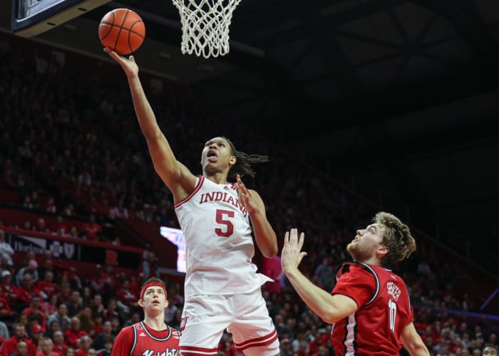 Indiana Hoosiers forward Malik Reneau (5) drives to the basket as Rutgers Scarlet Knights guard Cam Spencer (10) and guard Paul Mulcahy (4) defends during the first half at Jersey Mike's Arena.